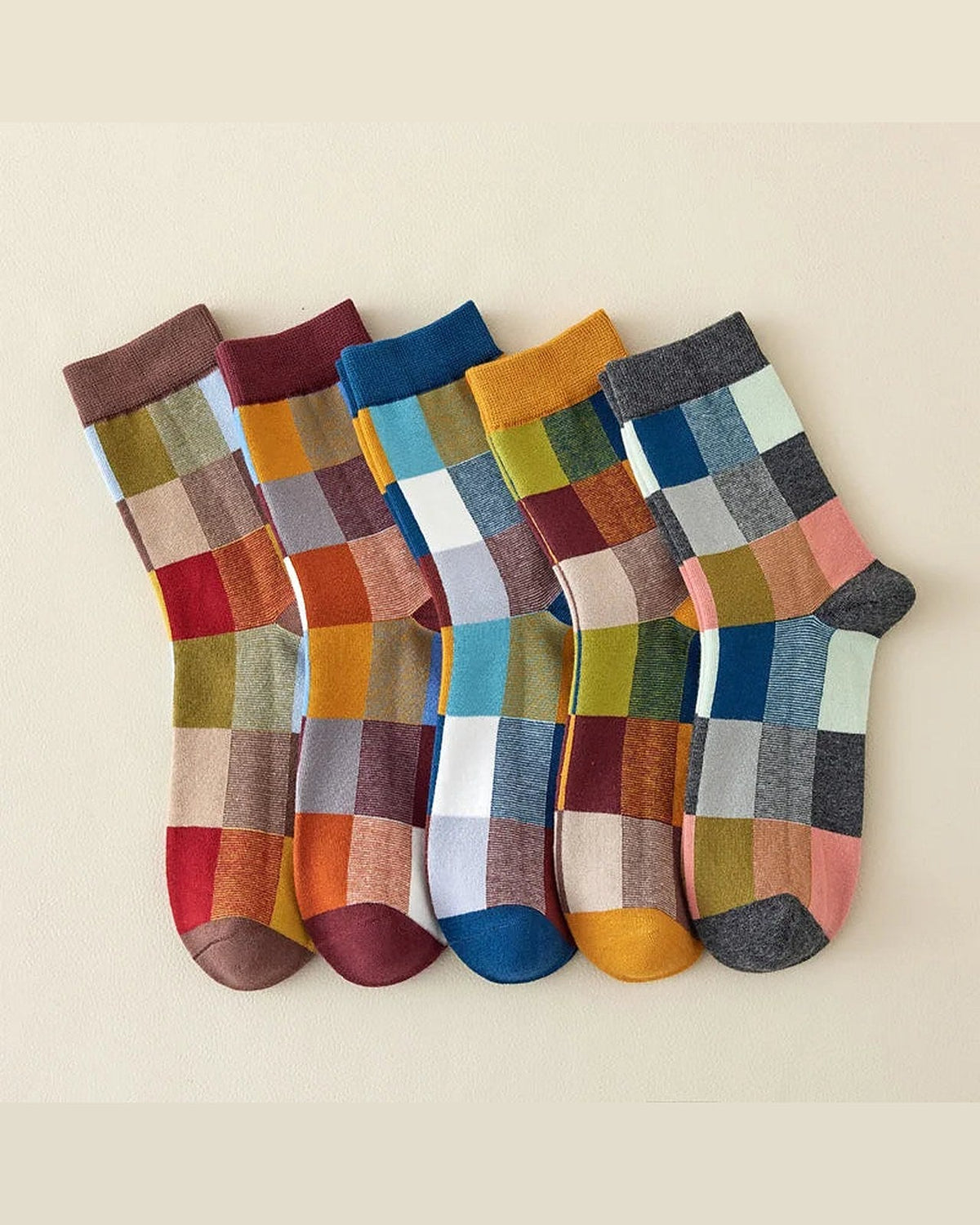 Five pairs of colour block dress socks on beige