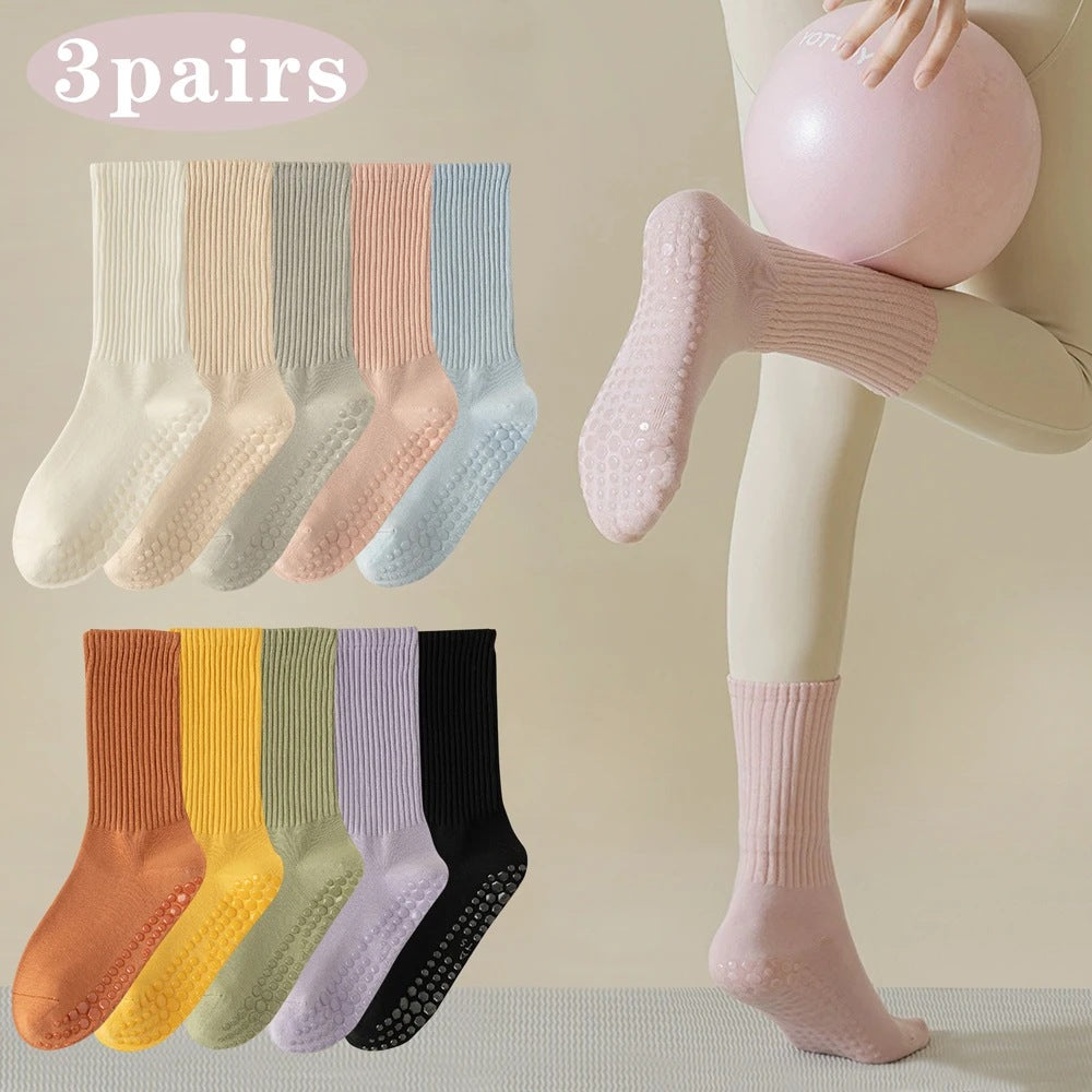 Soft solid mid-crew grip socks worn in the studio, shown in a range of shades