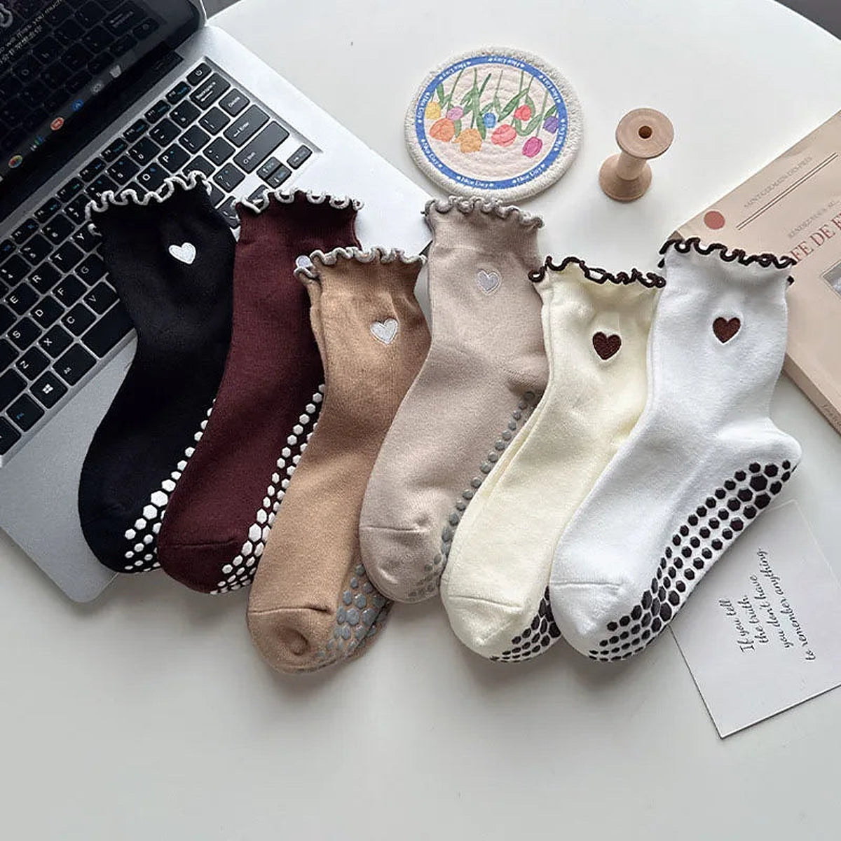 Heart-embroidered ruffle grip socks flat lay